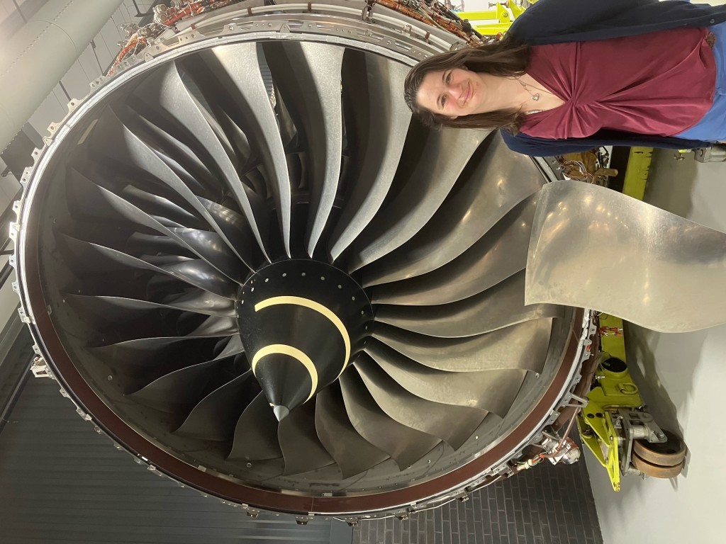 Above and top: Nicole Elders in front of one of the enormous aeroplane engines she works on before they take to the skies