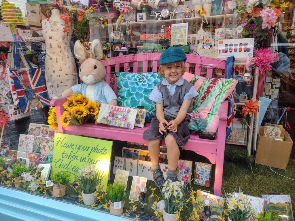 Above: Young Graham sits down on the job in Medici’s window display