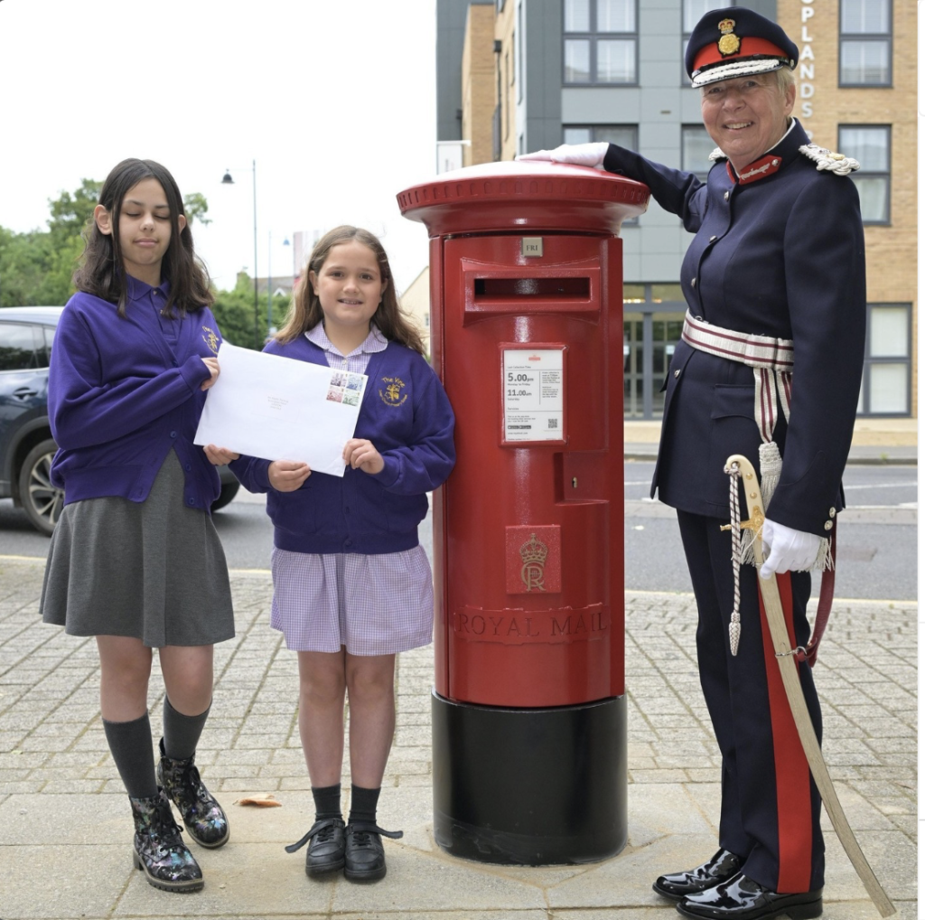 Above: Julia Spence with some of the pupils who helped unveil the new post box