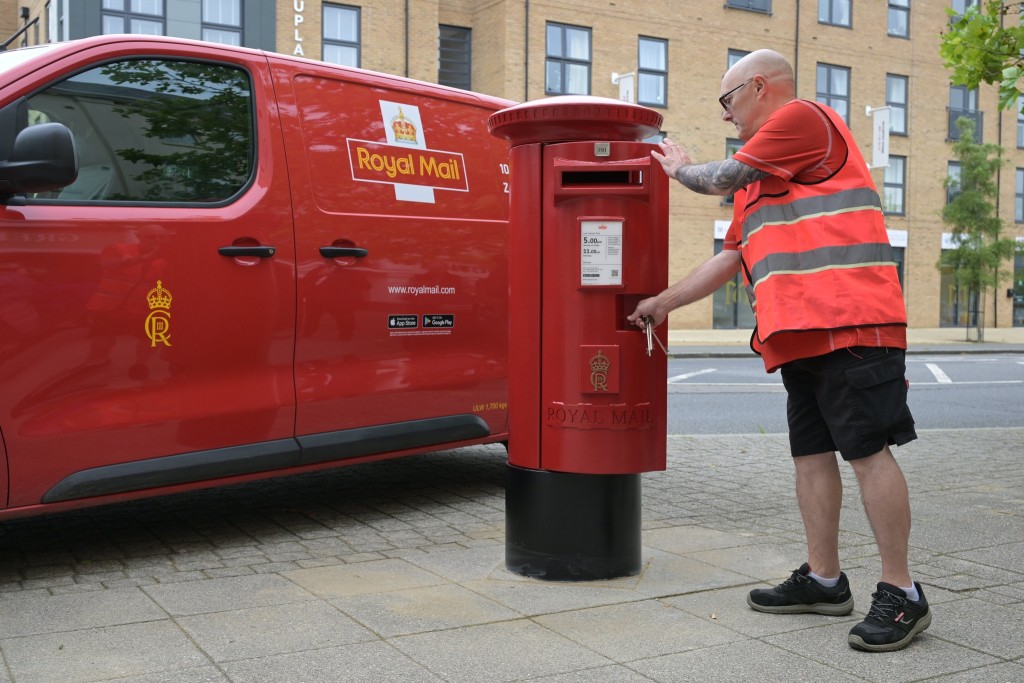 Above & top: The 508-year-old delivery service now has Charles III post boxes