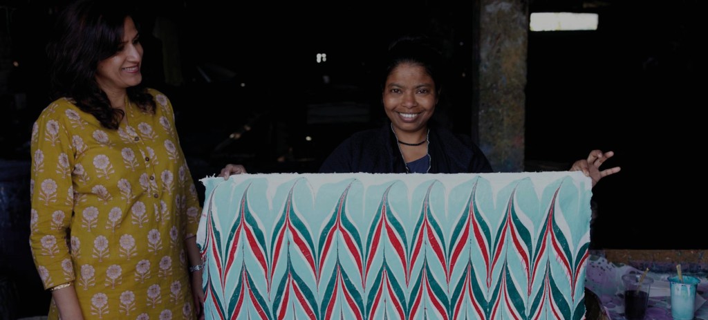 Above: Rani (left) has her paper made from cotton waste