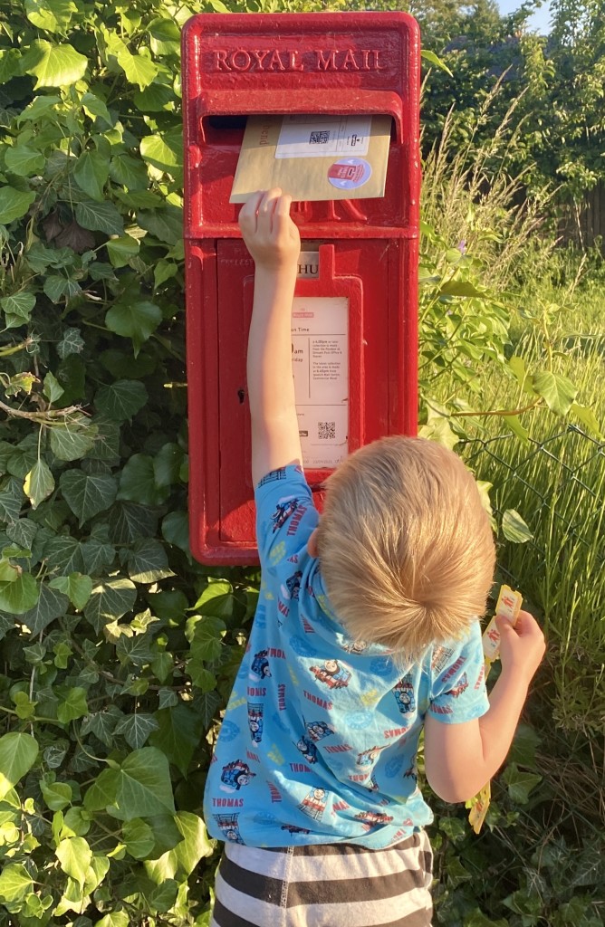 Above: Little Arlo loves helping his mum – and spotting post boxes!