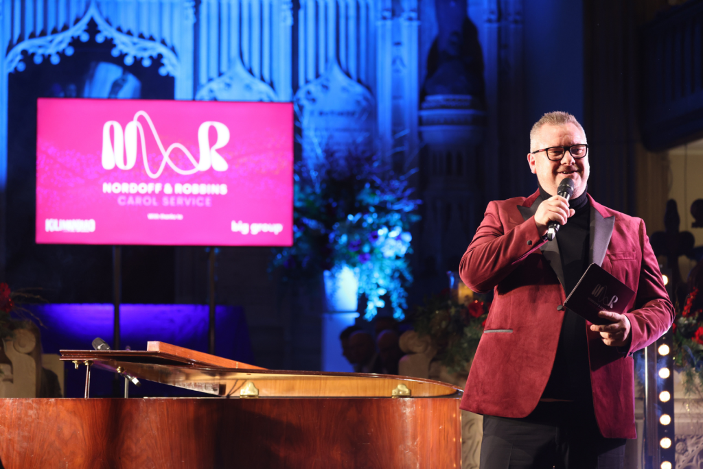 Above & top: Tony Mortimer performing Stay Another Day at this year’s carol service (Image: John Marshall)